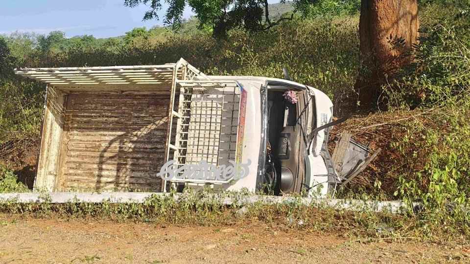 Goods vehicle overturns after hitting electric pole